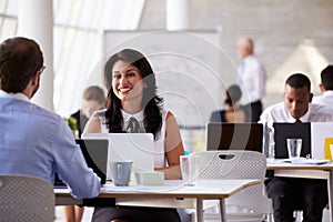 Businesspeople Working At Desks In Modern Office