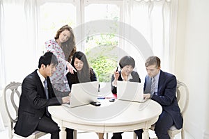 Businesspeople working on laptop