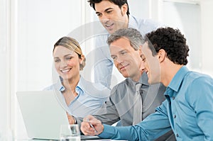 Businesspeople Working At Laptop