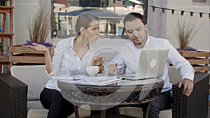 Businesspeople working with laptop computer in cafe. Business, technology and people.