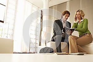 Businesspeople Working In Office Lobby