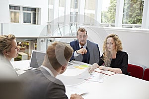 Businesspeople Working Together At Desk In Modern Office