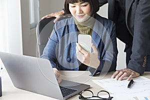 Businesspeople working together with laptop in modern office.