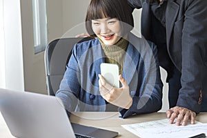 Businesspeople working together with laptop in modern office.