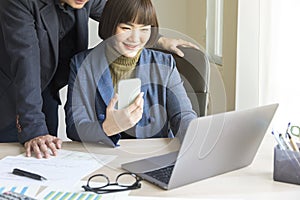 Businesspeople working together with laptop in modern office.