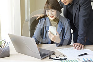 Businesspeople working together with laptop in modern office.