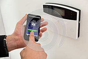 Businessperson Arming Security System photo