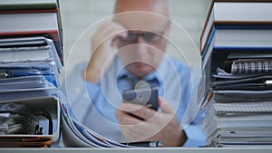 Businessperson In Blurred Image Reading Mobile Phone Online Message