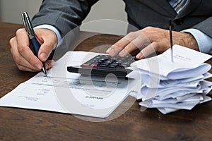 Businessperson calculating financial expenses photo