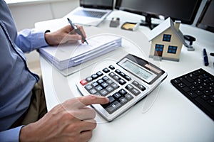 Businessperson Calculating Property Tax photo