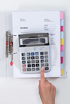 Businessperson Calculating Tax With Calculator