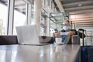 Businessperson with a cellphone sitting in the armchair