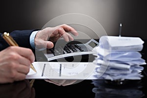 Businessperson Checking Invoice