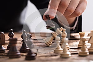 Businessperson Checkmating King Chess Piece With Rook