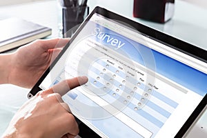 Businessperson Filling Online Survey Form On Digital Laptop