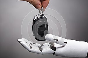 Businessperson Giving Car Key To Robot