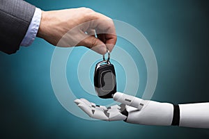 Businessperson Giving Car Key To Robot