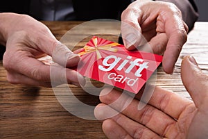 Businessperson Giving Gift Card To Colleague
