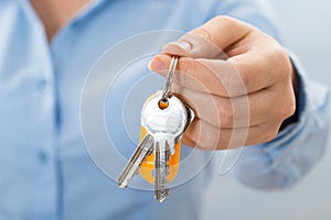 Businessperson hand holding key photo