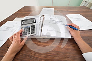 Businessperson hands calculating bill