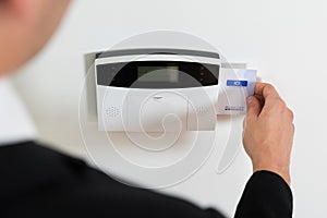 Businessperson Hands Inserting Keycard In Security System photo