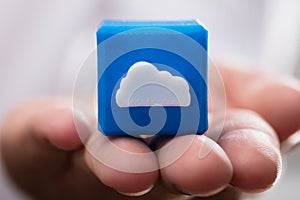 Businessperson holding cloud icon cubic block