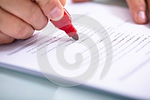 Businessperson Holding Marker On Document