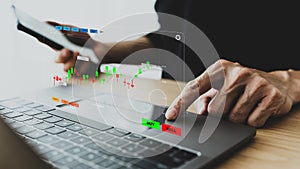 Businessperson, investor using laptop for trading. Trader data and information analysis chart for planning in strategy of stock