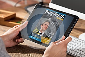 Businessperson Looking At Business Magazine