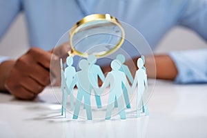 Businessperson Looking Human Figures With Magnifying Glass