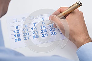 Businessperson Marking On Calendar