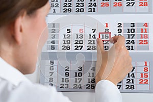 Businessperson Marking On Calendar