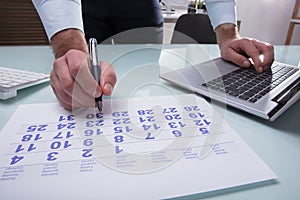 Businessperson Marking With Pen On Calendar