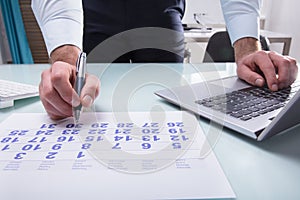 Businessperson Marking With Pen On Calendar