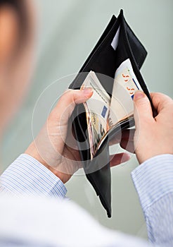 Businessperson with open wallet