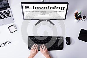 Businessperson Preparing E-invoicing Bill On Computer