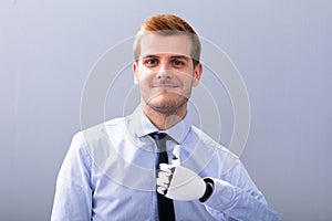 Businessperson With Prosthetic Limb Showing Thumb Up