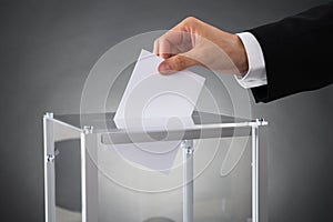 Businessperson Putting Ballot In Box