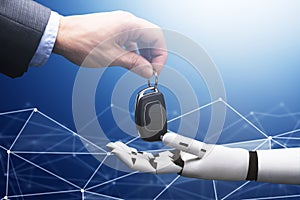 Businessperson`s Hand Giving Car Key To Robot