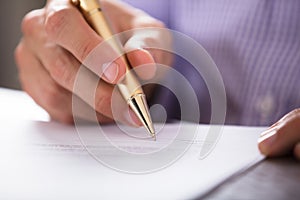 Businessperson`s Hand Signing Document With Pen