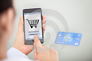 Businessperson shopping online with mobile phone and credit card