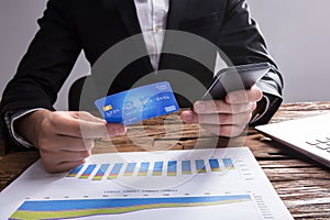 Businessperson Shopping Online With Mobile Phone And Credit Card