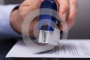 Businessperson Stamping Document