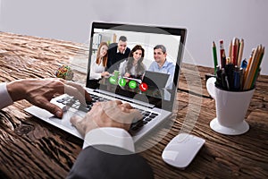 Businessperson Video Conferencing With Colleague On Laptop