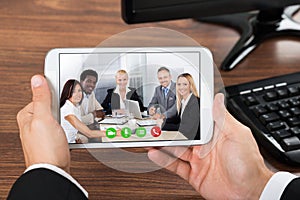 Businessperson video conferencing on mobile phone