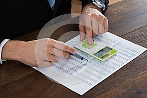 Businessperson Working With Accounting Document