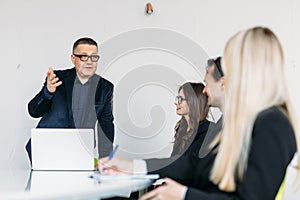 Businessteam discussing together in conference room during meeting at office
