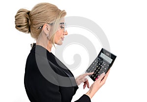 Businesswoman accountant in a black suit clicks on a calculator to calculate tax financial expenses