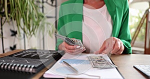 Businesswoman or accountant counting dollar bill at workplace