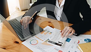 businesswoman accountant working on desk office with using a calculator to calculate the numbers, finance accounting